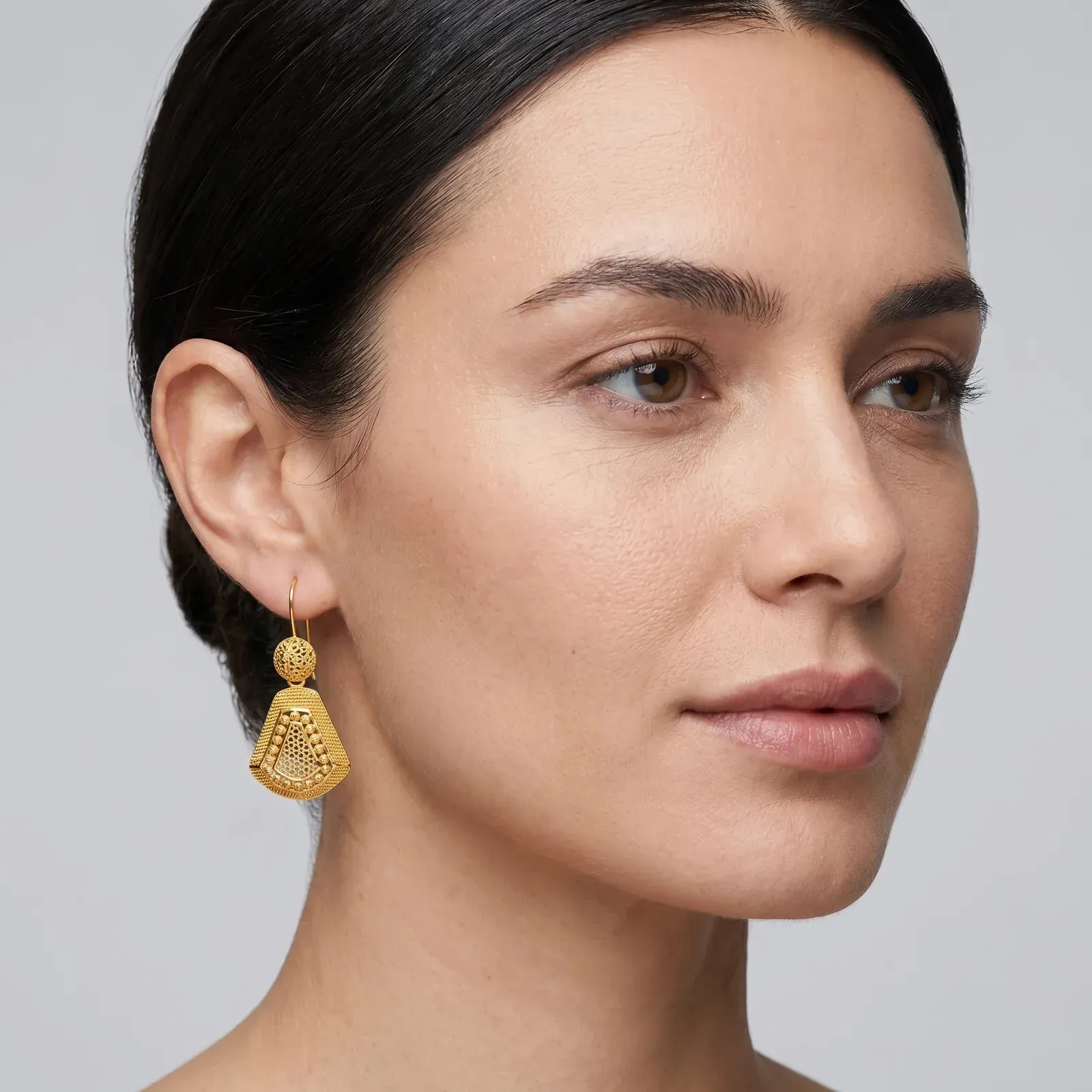 A portrait of a model wearing the Kolkata Fan Drop Earrings
