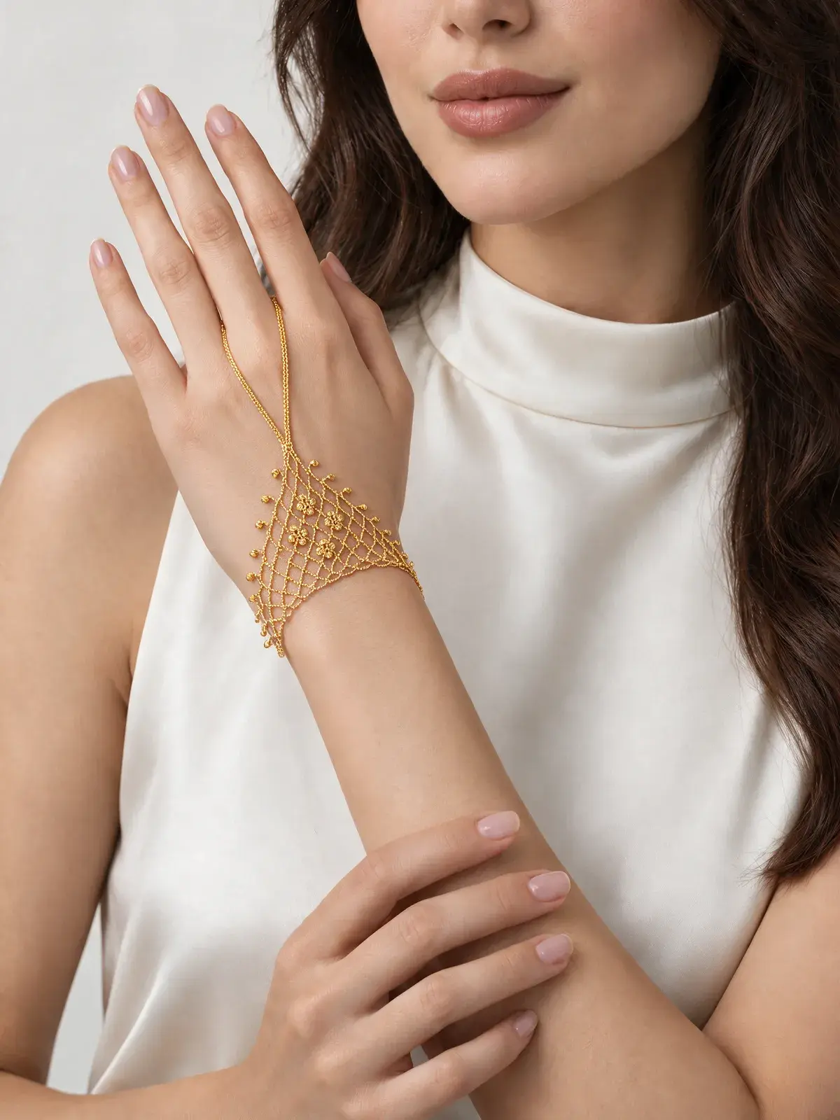 A model wearing the Flower Palm Hand Bracelet in 21K yellow gold